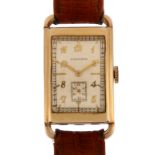 LONGINES - an American 10k gold filled mechanical wristwatch, circa 1930s, curved rectangular