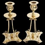 A fine pair of Victorian silver-gilt table candlesticks, each drip pan raised on shaped and