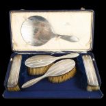 An Art Deco George V 5-piece silver travelling dressing table set, comprising 2 hairbrushes, 2