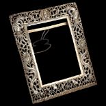 A Chinese export silver photo frame, relief embossed and pierced dragon and phoenix decoration,