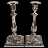 A pair of 18th century Neo-Classical silver table candlesticks, with relief embossed acanthus leaf