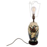 A Moorcroft cream ground table lamp with waterlily and bulrush decoration, height to top of base