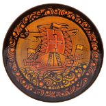 A large Poole orange ground Aegean charger, signed Diana Davis, depicting a sailing ship, 40.5cm