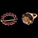 An unmarked gold and citrine set dress ring, and a garnet and gilt-metal set brooch (2)