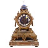 An Antique French gilt-bronze mantel clock, with enamel display, Roman numerals, with base (A/F)