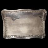 A French silver dressing table tray of serpentine form, with cast decorated edge, W34cm, 18.7oz
