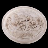 An oval plaster plaque depicting cherubs leading a lion, W57cm
