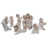 A quantity of Lladro angel porcelain figurines, several playing musical instruments, and a group