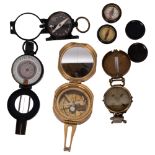 A collection of various compasses, including 2 pocket compasses, a brass-cased compass, a