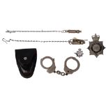 A group of Police items, to include 2 Metropolitan Police whistles, a badge, and a pair of leather-