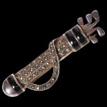 A silver and marcasite gold club and bag design brooch, L6cm Good overall condition, light surface