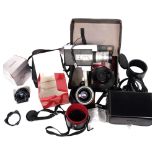 A group of Sigma lenses, in associated protective cases or boxes, including Sigma APO zoom lens,