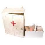 A painted First Aid cabinet, with glass shelves and some original contents including bandages, H47cm