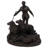 A bronze effect composition sculpture of a shepherd, dog and sheep, H26cm