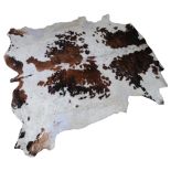 A large cowhide, W230cm x 220cm approx Good overall condition, there are a few areas of loss towards