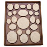 A 3-tier pine case containing 67 Grand Tour plaster intaglios, each tier W23cm, H28cm, with lid