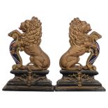 A pair of gilded cast-iron heraldic rampant lion door stops, H36cm