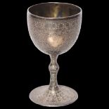 An ornate Persian white metal goblet on turned foot, with allover engraved decoration, H11.5cm, 5.