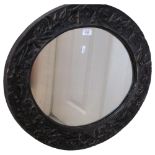 A oval carved wood mirror, with floral carved decoration, 52cm x 62cm
