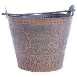 Antique ornate embossed copper pail, with floral and animal decorated panels, and the base