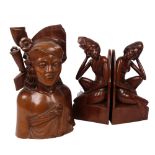 A pair of carved Balinese bookends, and a Balinese hunter bust by Fatimah, Bali, all signed to base,