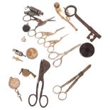 A group of various scissors, including a candle snuffer, a swan design sewing scissors, grape