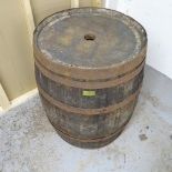 A vintage coopered-oak barrel. With label for Woodberry of Leamington Spa. 74x88cm.