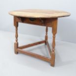 A 19th century oak circular topped cricket table with single frieze drawer. 75x62cm.