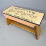 A painted pine bench of small size, with painted lettering for Westmoreland Grocery Company.