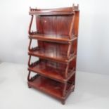 A Chippendale style five tier mahogany waterfall bookcase, each tier with pierced fretwork