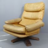A mid-century Danish design teak and leather upholstered swivel lounge chair.