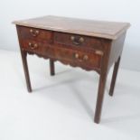 An 18th century crossbanded mahogany lowboy, with 2 short and 1 long drawer, on chamfered legs.