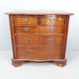 A modern mahogany serpentine-front chest of two short and three long drawers. 99x88x52cm.