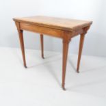 A Victorian mahogany fold-over card table, with applied carved decoration, square tapered legs and