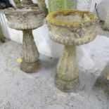 A pair of two-section weathered concrete urns on stands. 39x72cm.