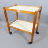 A mid-century two-tier teak drinks trolley with formica tops. 61x70x38cm.