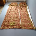 Two pairs of good quality red and gold lined curtains with floral brocade design and drop fringe