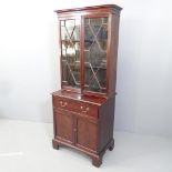 A 19th century mahogany two-section bookcase on cabinet. 66x165x43cm.