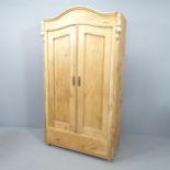 A continental pine two door arch top wardrobe, 103x181x45cm