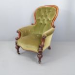 A Victorian mahogany and upholstered spoon back armchair.