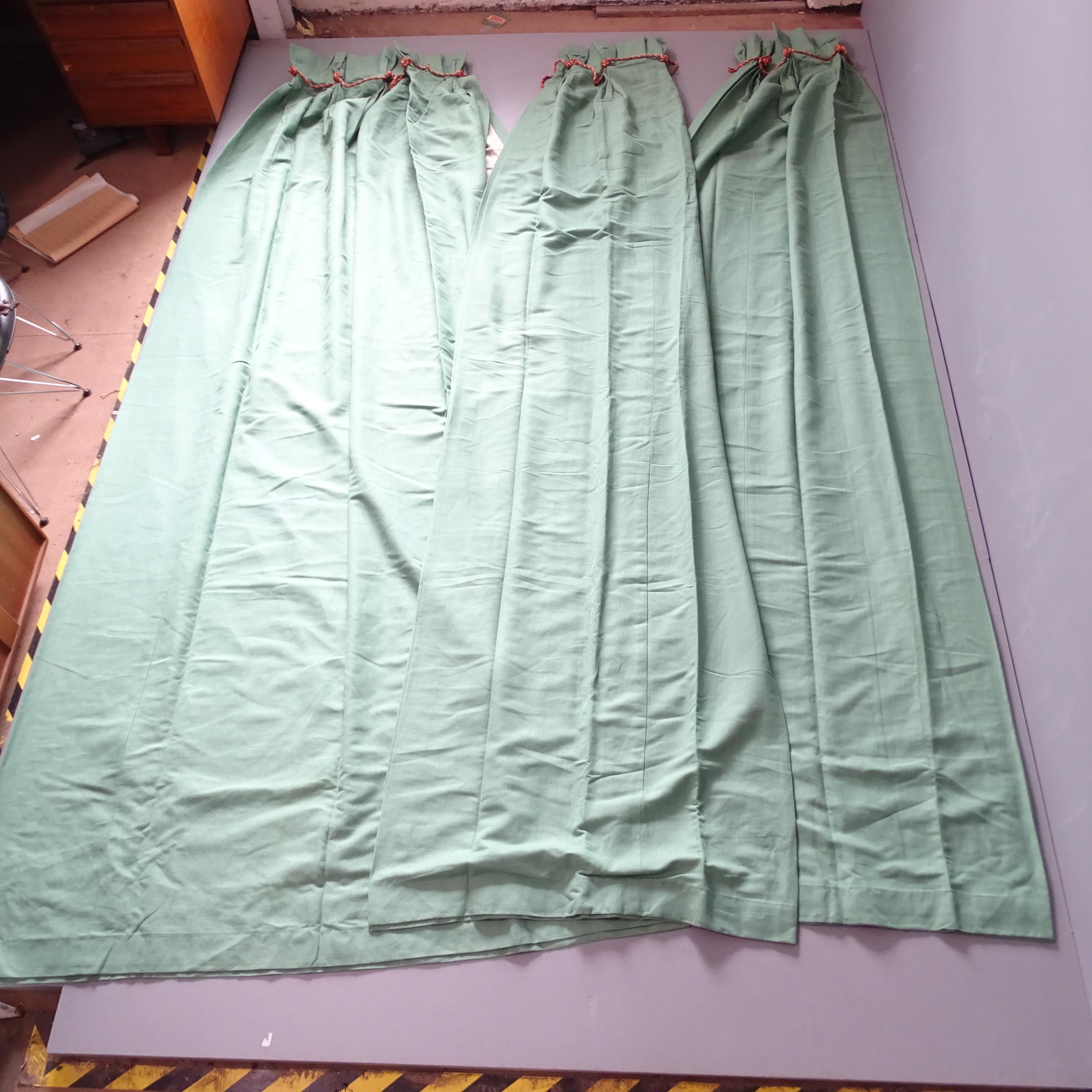 A pair of green cotton lined curtains. Drop 335cm, width (top) 130cm, (base) 320cm, and a matching
