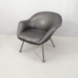 A mid century black leather upholstered lounge chair, raised on tubular metal legs. Various