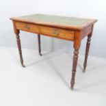 A Victorian mahogany writing table, with tooled green leather skiver, two frieze drawers and