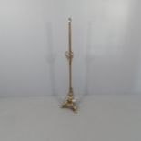 A brass standard lamp with fluted column and tripod base. Height to bayonet 148cm.