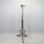 A wrought iron black painted telescopic standard lamp. H - 140cm.