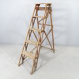 A vintage pine folding step ladder, with metal plaque reading "The Hatherley folding lattistep".