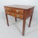 A George lll oak low boy, fitted with two short and one long drawer, raised on square chamfered