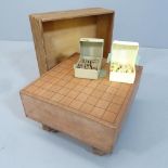 A Japanese Shogi set comprising a wooden game board and counters. 35x21x31cm.