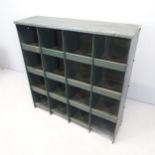 A painted metal industrial storage unit with 16 open compartments. 92x92x26cm.