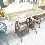 A marble topped garden table on iron Singer sewing machine base. 100x97x50cm.